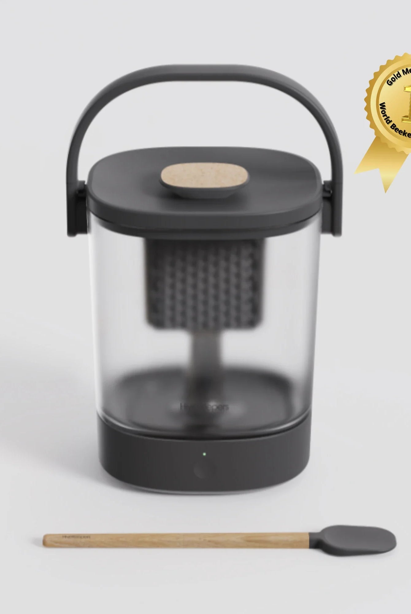 Micro Honey Harvester with clear honey collection bowl and wooden stirring spoon, gold medal winner badge