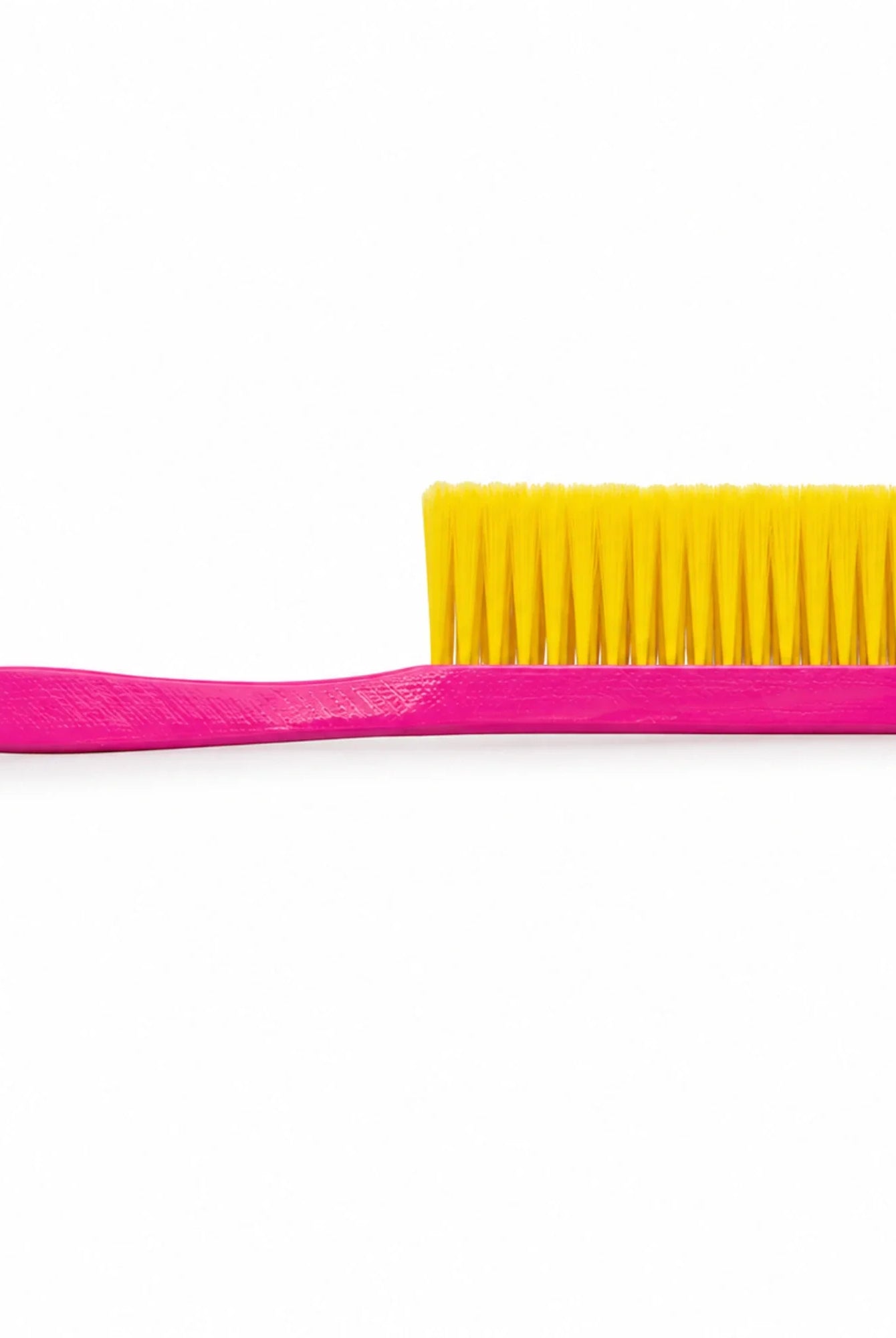 Pink OZ Armour beekeeping bee brush with two rows of yellow bristles, side view