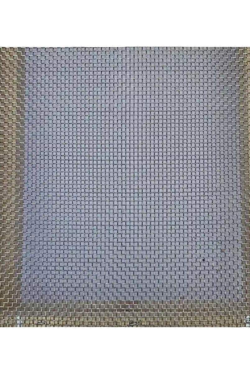 Close-up top view of stainless steel wire mesh on screened bottom board for beehive