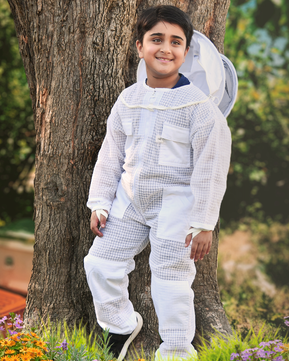 A Kid also wearing a beekeeping suit