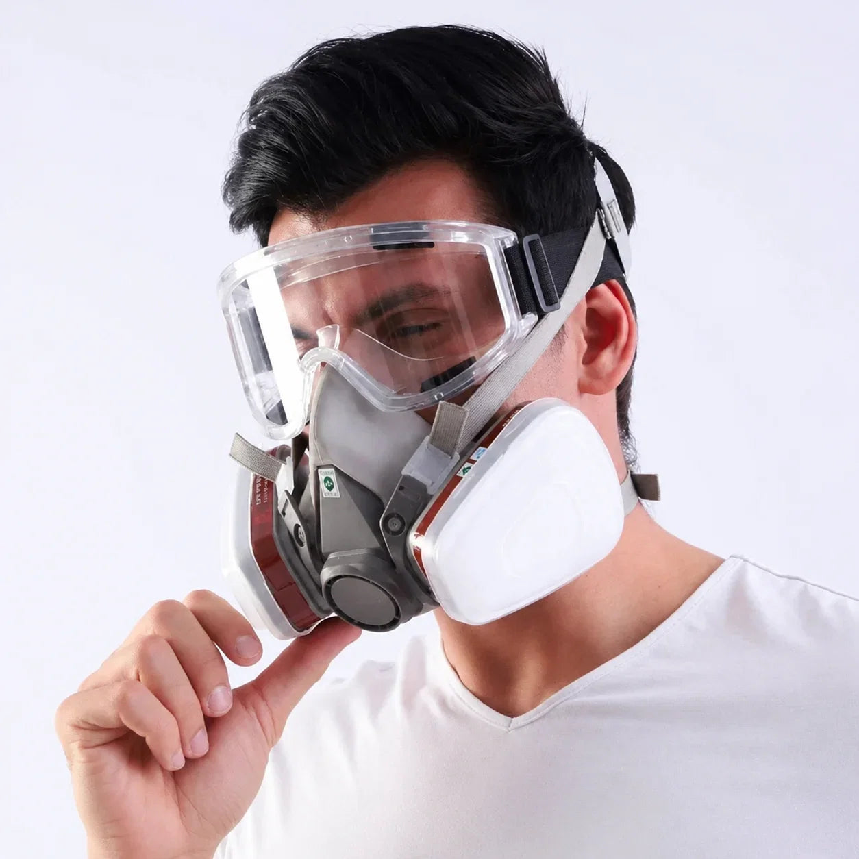 Man wearing half face respirator with safety goggles for oxalic acid vaporization beekeeping